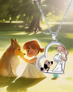 Detail of silver heart pendant featuring a girl, dog, rose and sparkling crystals