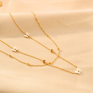 Double-layer titanium steel butterfly necklace with pink zircon on beige silk fabric