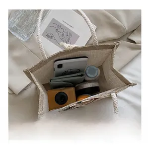 Interior view of beige woven tote bag showing large capacity for essentials like cameras