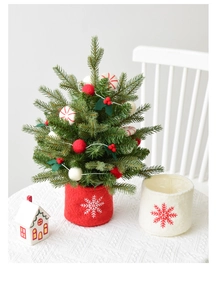 Detailed view of mini wool felt Christmas tree decorations with snowflake base