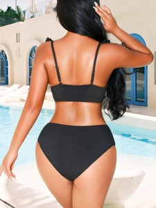 Detail view of black ribbed bikini back showing high-waisted cut and slim straps