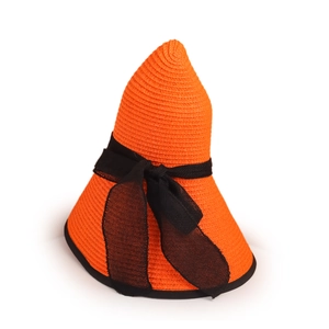 Detail of orange woven straw hat featuring a large black bow and contrasting ribbon