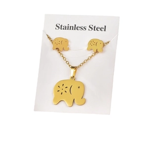 Golden stainless steel elephant necklace and earrings jewelry set on a clean white display card