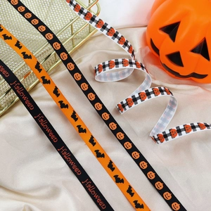 Detailed view of Halloween grosgrain ribbons with pumpkin, bat and letter patterns