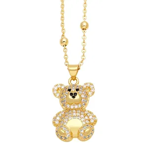 Elegant gold teddy bear pendant necklace with sparkling white and black cubic zirconia stones