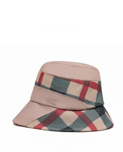 Detail showing checkered fabric patches and golden LOVE lettering on the bucket hat