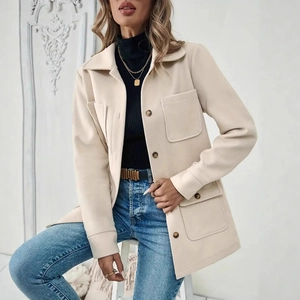 Detailed view of a beige shacket with wood-grain buttons and functional flap pockets