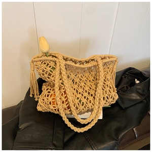 Detail of hand-woven hollow beige crochet bag on leather jacket with a yellow tulip