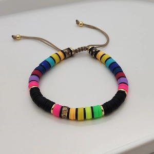 Detail of colorful Heishi clay beads bracelet with adjustable brown braided cord closure