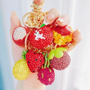 Creative rhinestone fruit keychains featuring strawberry, pineapple and apple designs