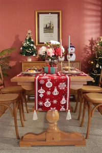 Detailed Christmas table runner with red jacquard snowflake patterns and white tassels