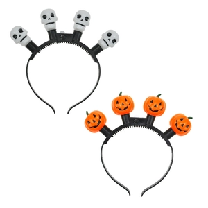 Detail of Halloween headbands featuring glowing white skulls and orange pumpkin designs