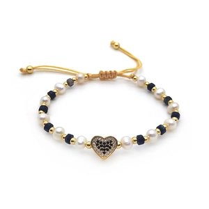 Handmade woven bracelet with heart pendant, pearls and natural black stones on yellow cord