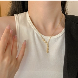 Detailed view of shimmering star-shaped pendants on a gold titanium steel necklace