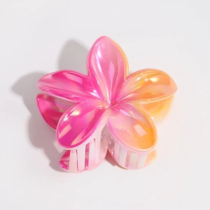 Macro detail of lily hair claw clip with pink-orange gradient and pearlescent finish