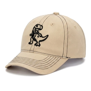 Detail of embroidered dinosaur pattern on beige cotton canvas baseball cap