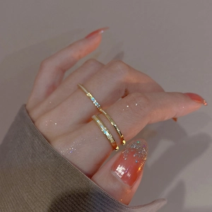 Close-up of dual-layer gold plated ring with shell inlay on female model finger