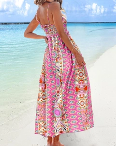 Back view of bohemian floral maxi dress with spaghetti straps on a tropical beach