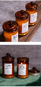 Scented soy wax candles in amber glass jars shown lit on dark wood and velvet textures