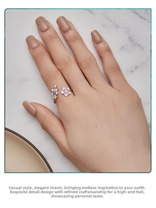 Detailed view of s925 silver ring with pink enamel cherry blossoms and micro-set leaves