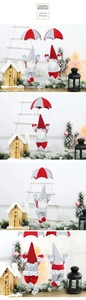 Detail view of gnome Christmas ornaments with parachutes in a snowy festive scene