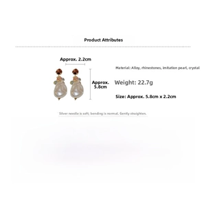 Detailed view of baroque pearl earrings with crystal accents and 5.8cm length specs