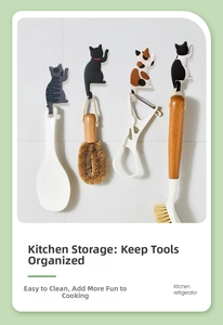Detailed view of 4 cute cat-shaped magnetic hooks holding kitchen tools on a white wall