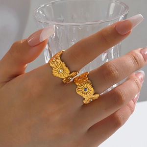 Minimalist gold flower rings with colorful zircon crystals on a model's hand