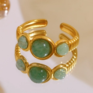 Macro detail of 18K gold plated ring featuring three green aventurine stones and mirror reflection