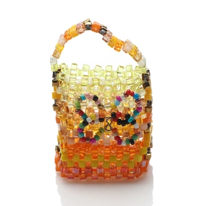 Macro detail of yellow and orange acrylic square beads used in handmade beaded handbags