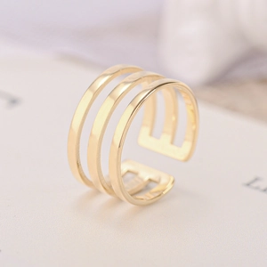 Detailed view of a gold-plated three-row open ring with a hollowed-out minimalist design