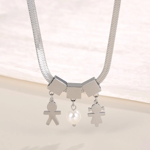 Close-up of silver snake chain featuring pearl and cartoon boy and girl figure charms
