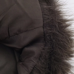 Detailed macro view of dark brown faux fur collar and durable twill fabric lining