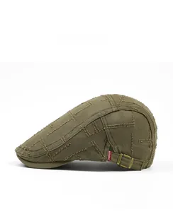 Close-up of military green vintage beret with frayed stitching and fashion label