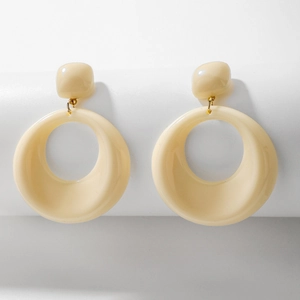 Detailed shot of retro cream acrylic geometric hoop earrings with gold metal accents