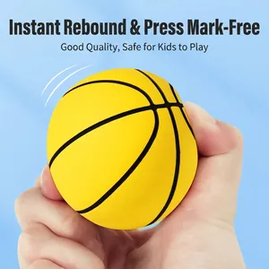 Bright yellow high-elastic rubber mini basketball being squeezed by hand for stress relief