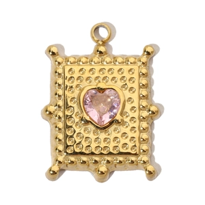 Detail of a gold rectangular pendant with pink heart gemstone and dotted texture