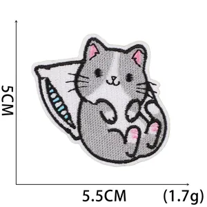 Detail view of cartoon cat embroidery patch on white background with 5.5cm size markings