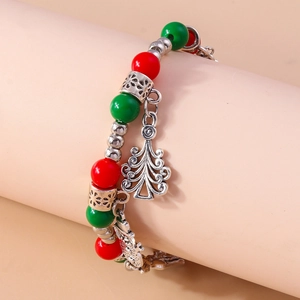 Close-up of Christmas beaded bracelet with red green beads and festive tree pendant