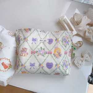 Detail of floral cotton makeup bag with teddy bear pattern and simple wish woven label