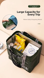 Close-up of green foldable shopping bag showing large capacity for groceries and laptop