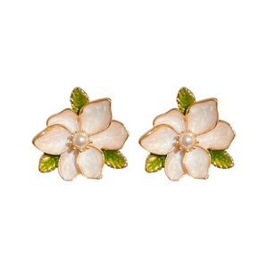 Sweet floral stud earrings with cream petals, green leaves, and pearls in gold finish
