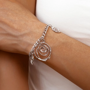 Detail of silver hollow rose pendant necklace with thick Cuban chain on model neck