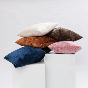 Artistic stack of soft plush velvet cushions with checkered texture in multiple colors