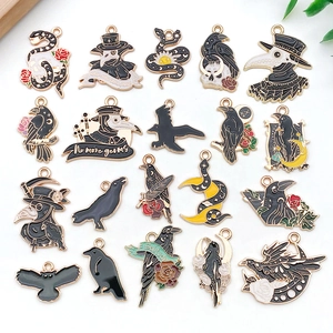 Detail of 20 enamel plague doctor and raven charms for jewelry making in black and gold