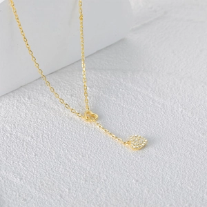 Detailed macro view of the gold-plated double heart pendants with sparkling zircon pavé