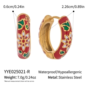 Detail view of red enamel hoop earrings with floral patterns and size specifications