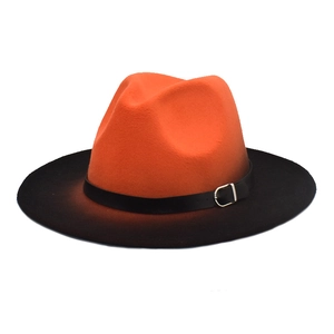 Detail of orange-black gradient fedora hat showing textured felt and black belt buckle