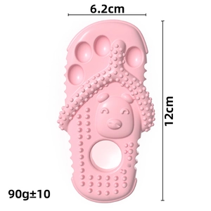 Pink slipper shaped dog chew toy with textured surface and cartoon bear detail