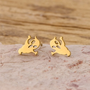 Macro shot of gold stainless steel ghost stud earrings with cutout eyes on stone